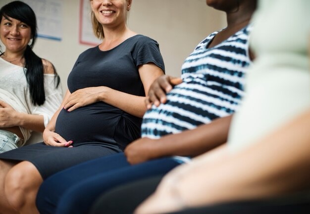 pregnant women sitting in a group