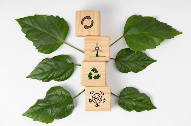 A wooden blocks with a logo and leaves.
